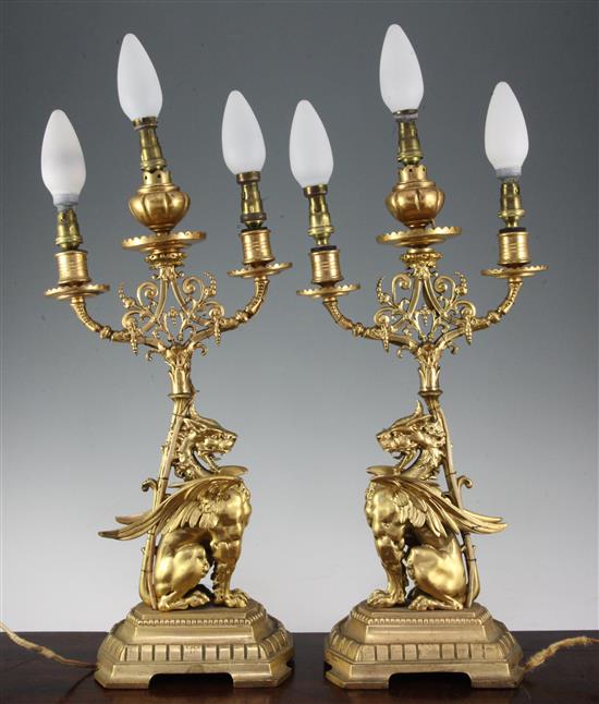 A pair of late 19th / early 20th century gilt bronze griffin three light table lamps, 23in. incl. bulbs